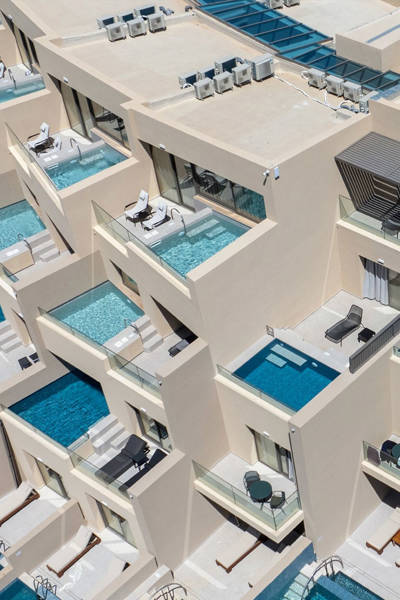 Daytime aerial view of Ventale Island Breeze Resort suites, each with private plunge pools and sun loungers on the balcony